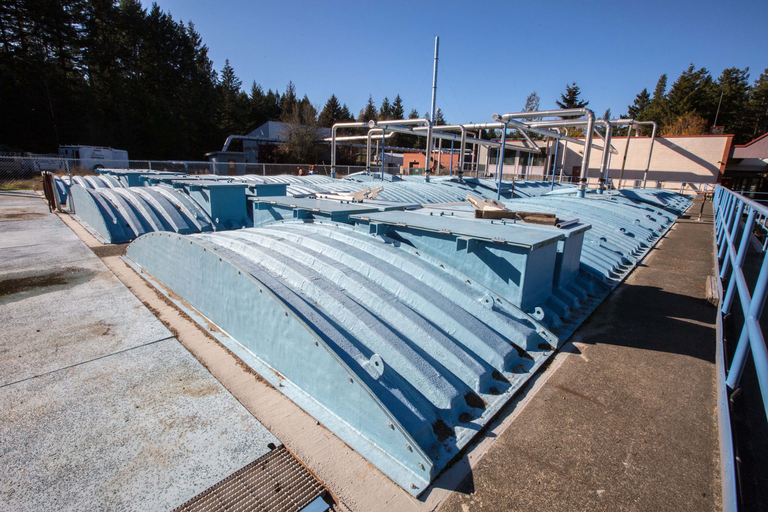 Wastewater treatment tanks with blue covers